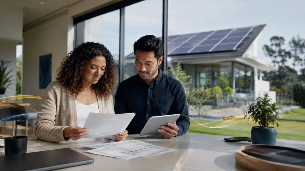Solar Financing Explained: Buy, Loan, Lease, or PPA? reviewing home plans in a modern space